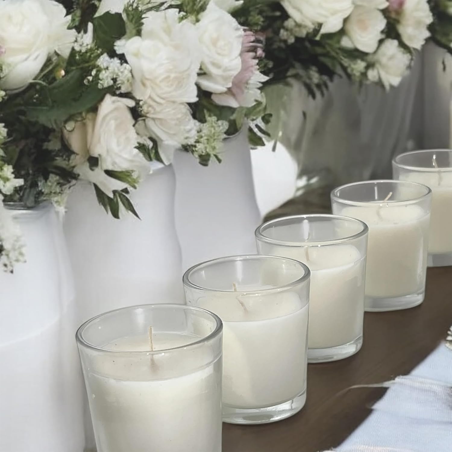 Stonebriar glass votive candles arranged beside white flowers