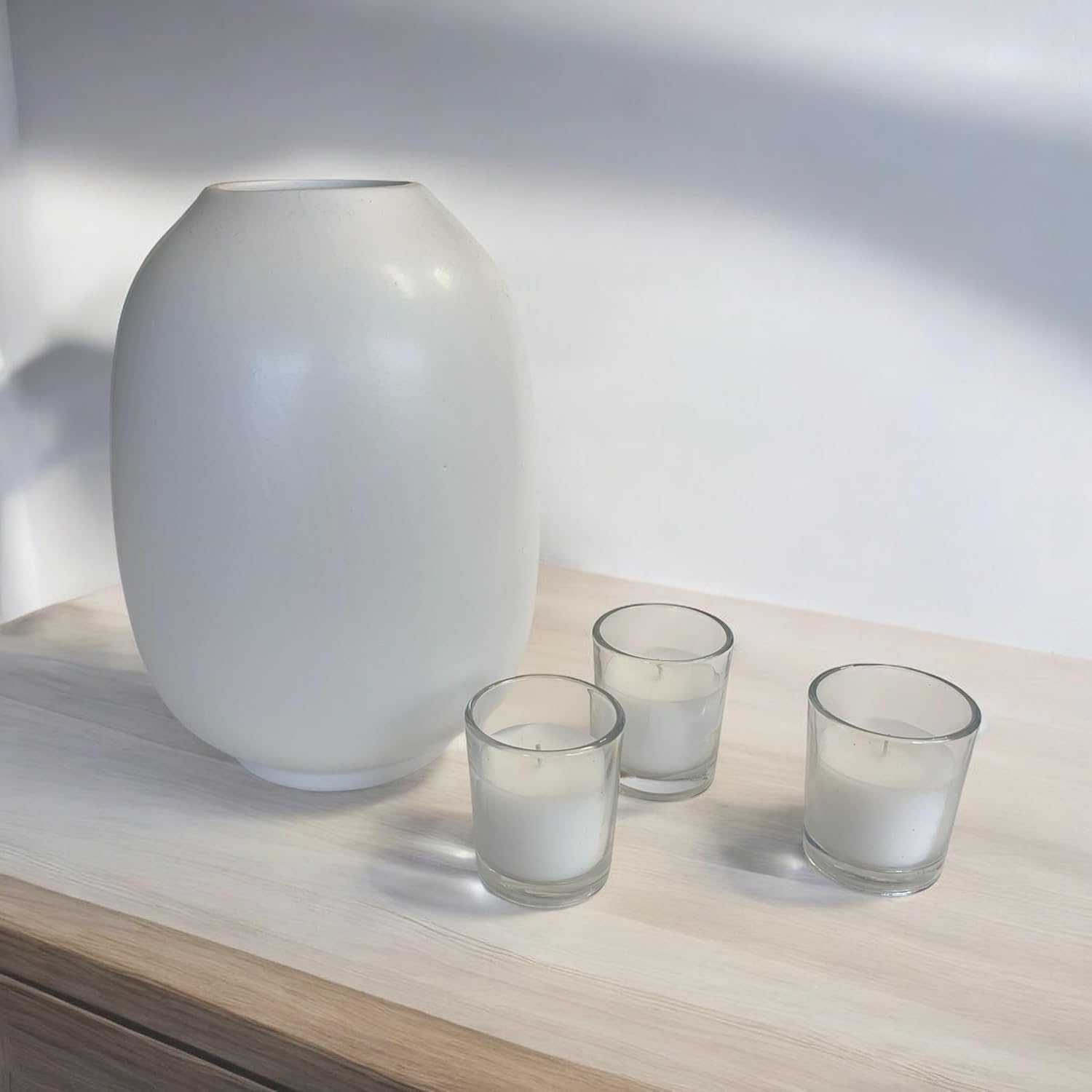 Stonebriar glass votive candles styled beside a white ceramic vase